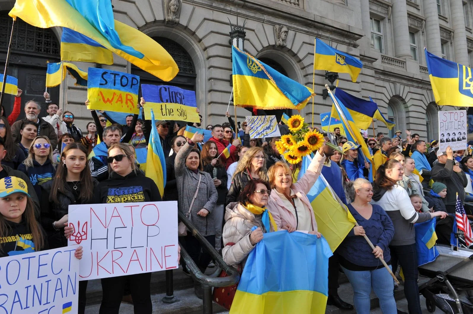 Community members holding Ukrainian flags at a rally in Northeast Ohio